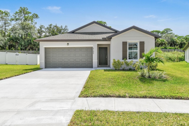 ranch-style home with a front yard, fence, stucco siding, concrete driveway, and a garage