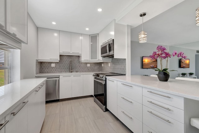 164 Normandy D, Delray Beach, FL 33484 - kitchen featuring a sink, modern cabinets, stainless steel appliances, backsplash, and white cabinetry