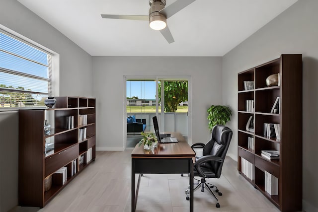 164 Normandy D, Delray Beach, FL 33484 - office area with a ceiling fan, baseboards, light wood-style flooring, and a healthy amount of sunlight