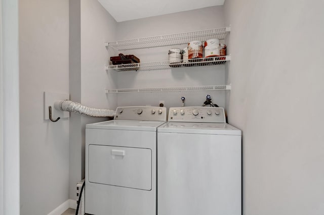 164 Normandy D, Delray Beach, FL 33484 - washroom with separate washer and dryer, baseboards, and laundry area