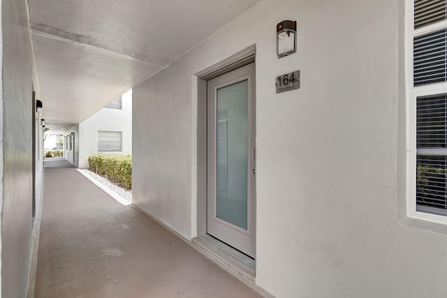 164 Normandy D, Delray Beach, FL 33484 - doorway to property featuring stucco siding