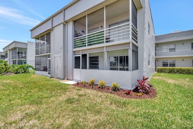 164 Normandy D, Delray Beach, FL 33484 - back of property featuring a yard and stucco siding
