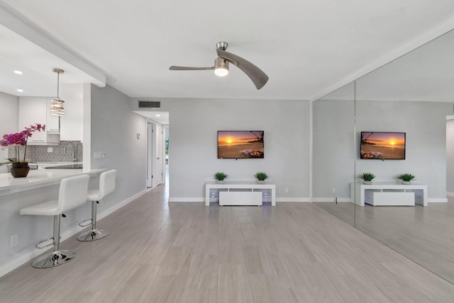 164 Normandy D, Delray Beach, FL 33484 - living area featuring light wood-style floors, visible vents, baseboards, and ceiling fan