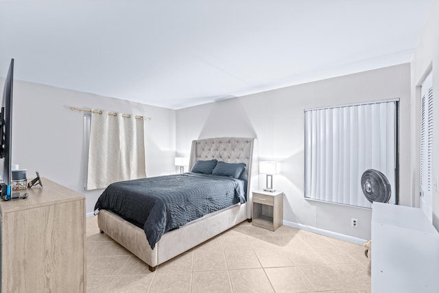 tiled bedroom with a closet