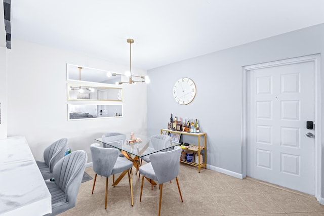 tiled dining room with a chandelier