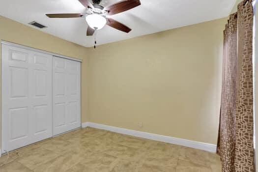 unfurnished bedroom with a closet, ceiling fan, and light colored carpet