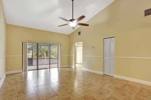 unfurnished room featuring high vaulted ceiling, light tile patterned floors, and ceiling fan