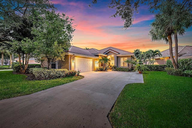 view of front of house with a yard and a garage