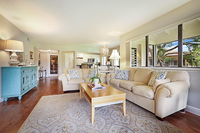 living room with dark hardwood / wood-style flooring and a textured ceiling