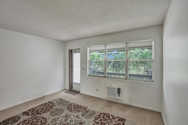 spare room with a textured ceiling and plenty of natural light