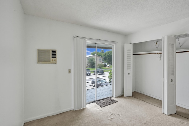 unfurnished bedroom featuring a textured ceiling and light carpet