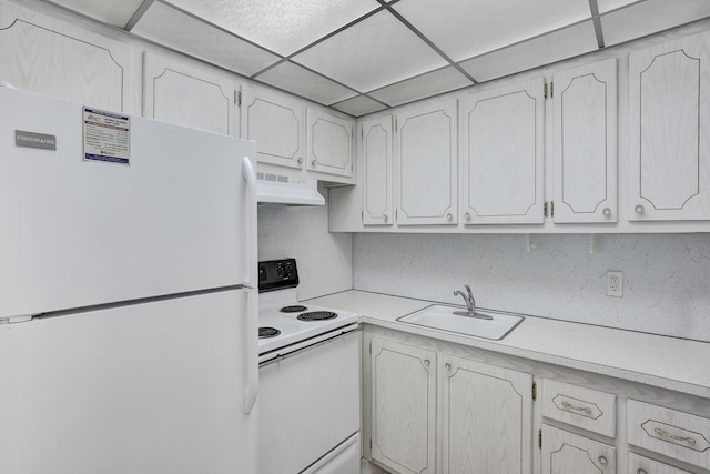 kitchen with white cabinetry, white appliances, a paneled ceiling, and sink