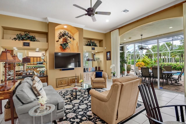 living room with crown molding, light tile patterned floors, and ceiling fan