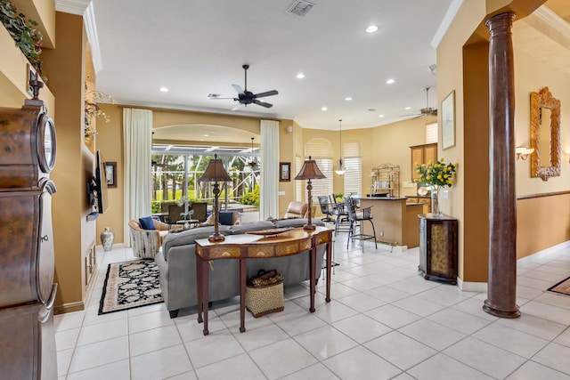 living room featuring crown molding, ceiling fan, light tile patterned floors, and ornate columns