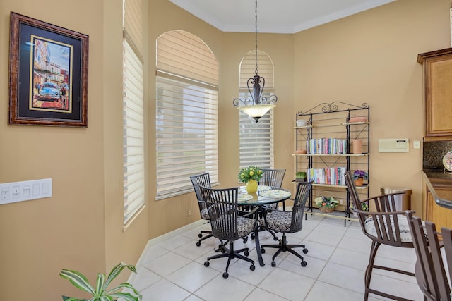 tiled dining space with plenty of natural light and ornamental molding