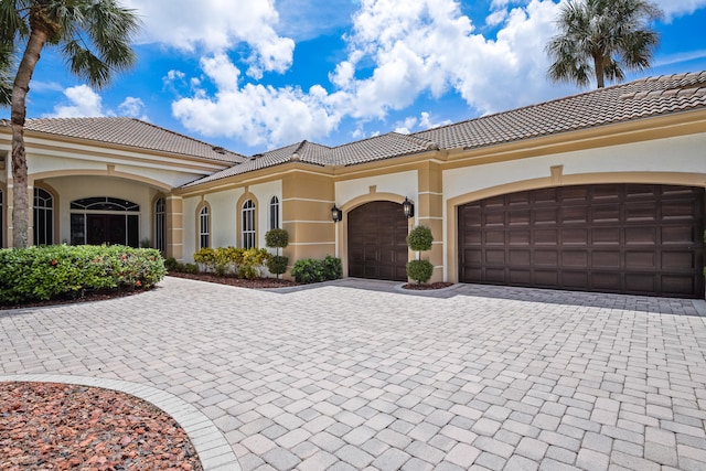 mediterranean / spanish-style home with a garage