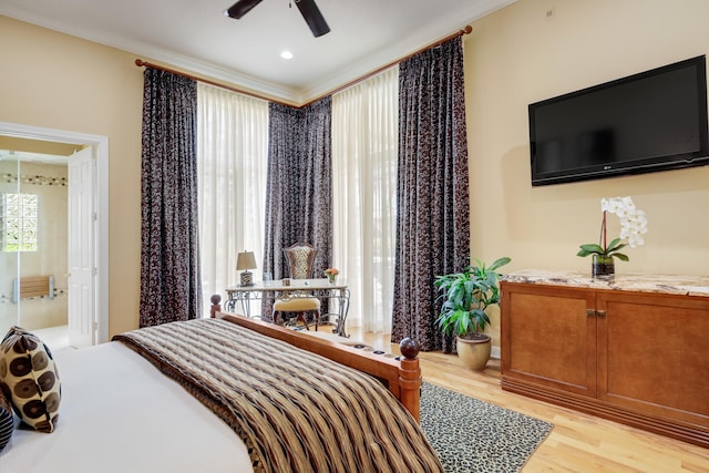 bedroom featuring crown molding, light hardwood / wood-style flooring, and ceiling fan