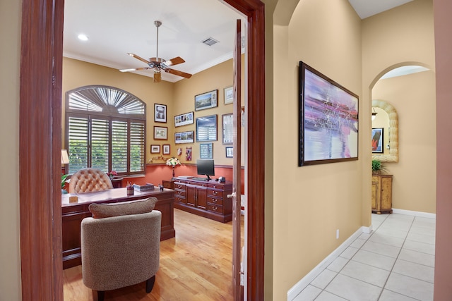 home office with ceiling fan, crown molding, and light hardwood / wood-style flooring