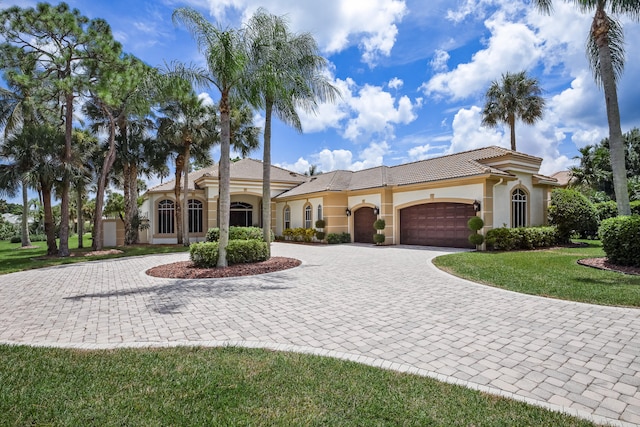 view of front of home featuring a garage and a front lawn