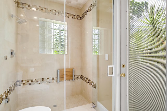 bathroom with a shower with shower door