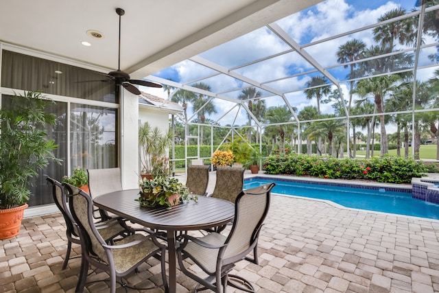 sunroom / solarium with ceiling fan and a pool