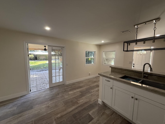 kitchen with visible vents, dark wood-type flooring, a sink, recessed lighting, and white cabinets