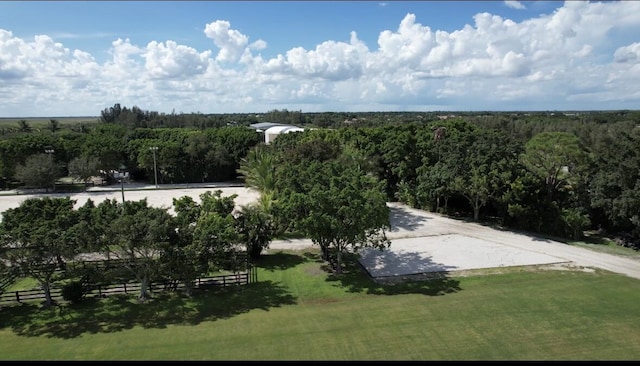 birds eye view of property featuring a view of trees