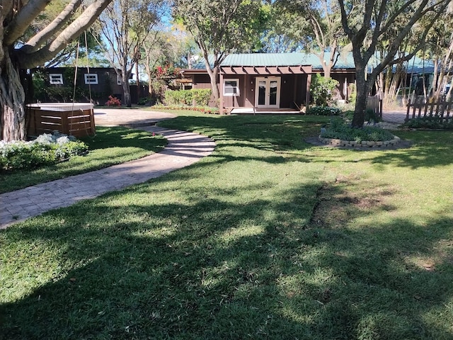 view of yard featuring french doors and a hot tub