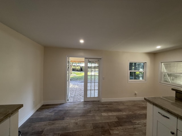 interior space with recessed lighting, baseboards, and dark wood-style floors