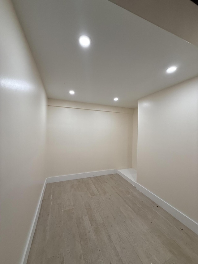 finished below grade area featuring recessed lighting, light wood-type flooring, and baseboards