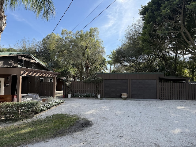 exterior space featuring driveway and fence