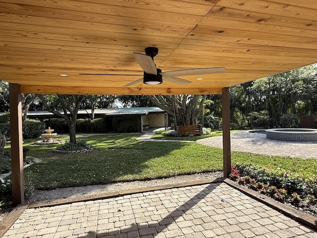 view of patio / terrace featuring an outdoor hot tub and ceiling fan