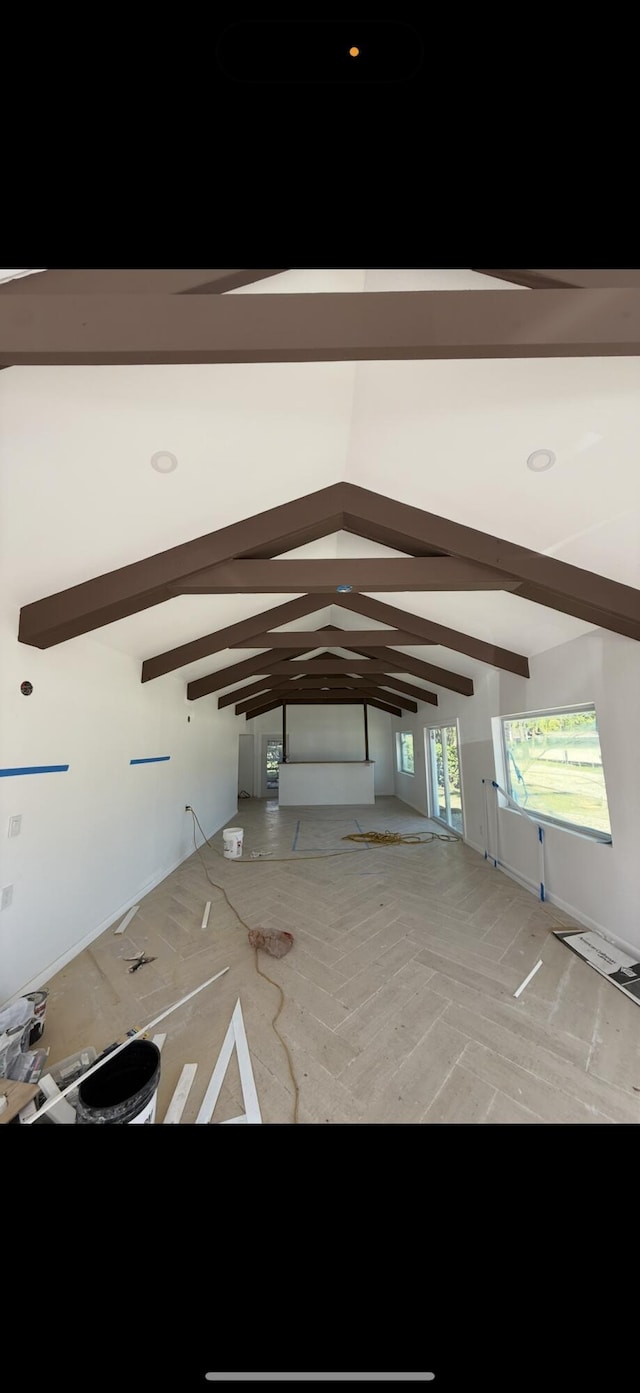 interior space featuring lofted ceiling with beams