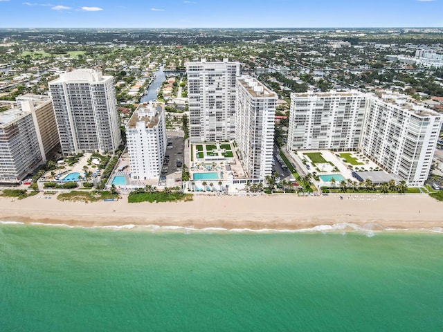 bird's eye view with a water view and a beach view