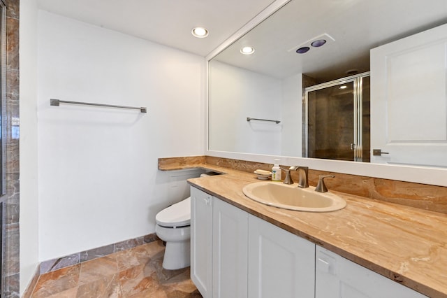 bathroom with walk in shower, vanity, and toilet