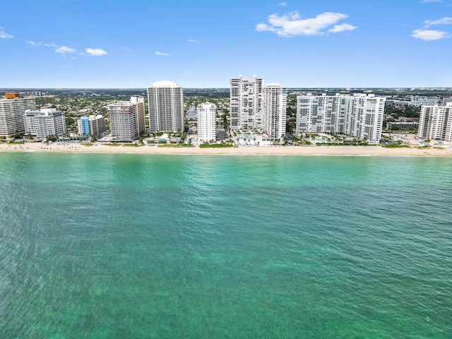 birds eye view of property with a beach view and a water view