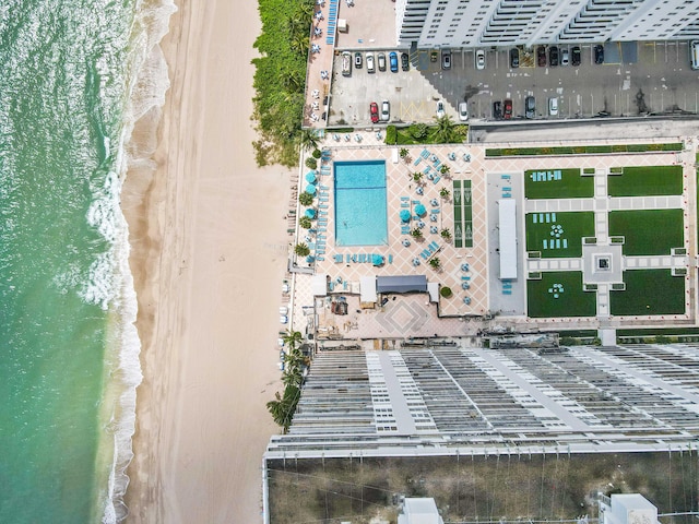 birds eye view of property featuring a water view and a beach view