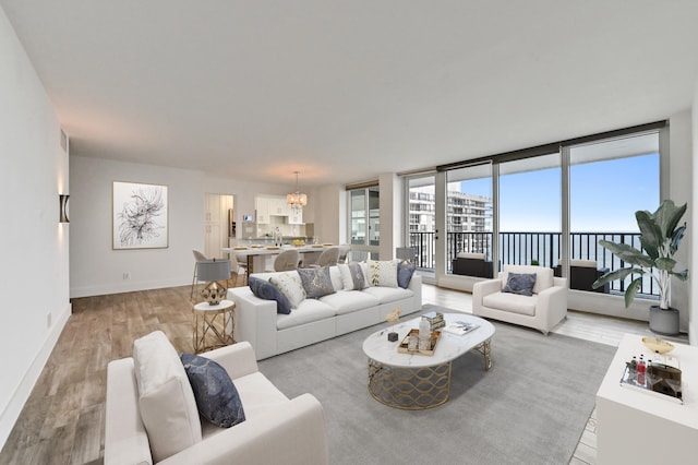 unfurnished living room with wood-type flooring and a notable chandelier