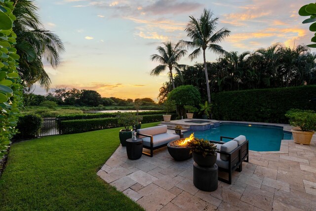 back house at dusk featuring a patio