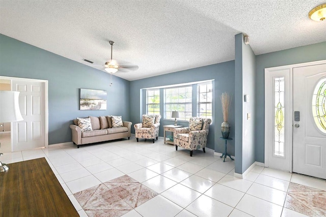 entryway featuring light tile patterned floors, a textured ceiling, vaulted ceiling, and ceiling fan