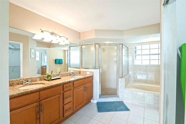 bathroom featuring vanity, plus walk in shower, and tile patterned flooring