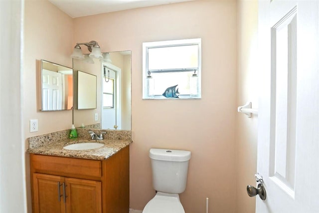 bathroom with toilet and vanity