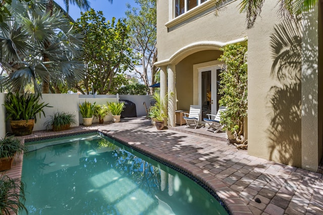 view of pool featuring a fenced backyard and a patio