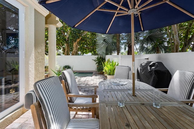 wooden deck with a patio area and area for grilling