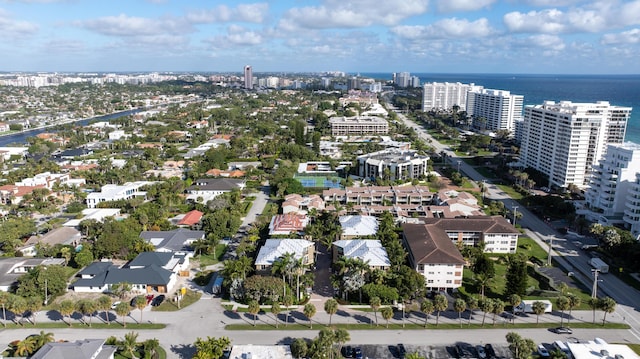 drone / aerial view featuring a water view and a view of city