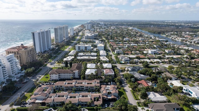 birds eye view of property featuring a water view and a city view