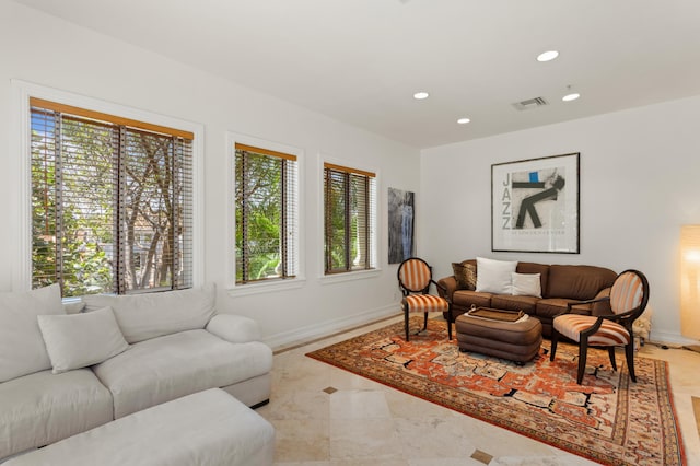 living area with baseboards, visible vents, and recessed lighting