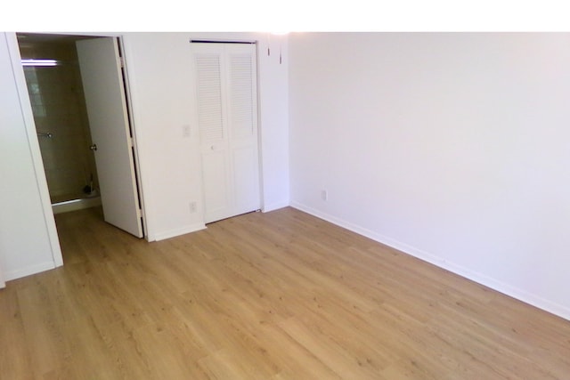 unfurnished bedroom with a closet and light hardwood / wood-style flooring