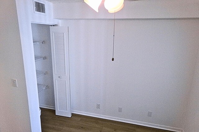 unfurnished bedroom featuring dark wood-type flooring