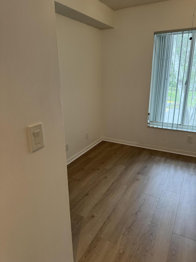 unfurnished room with light hardwood / wood-style floors